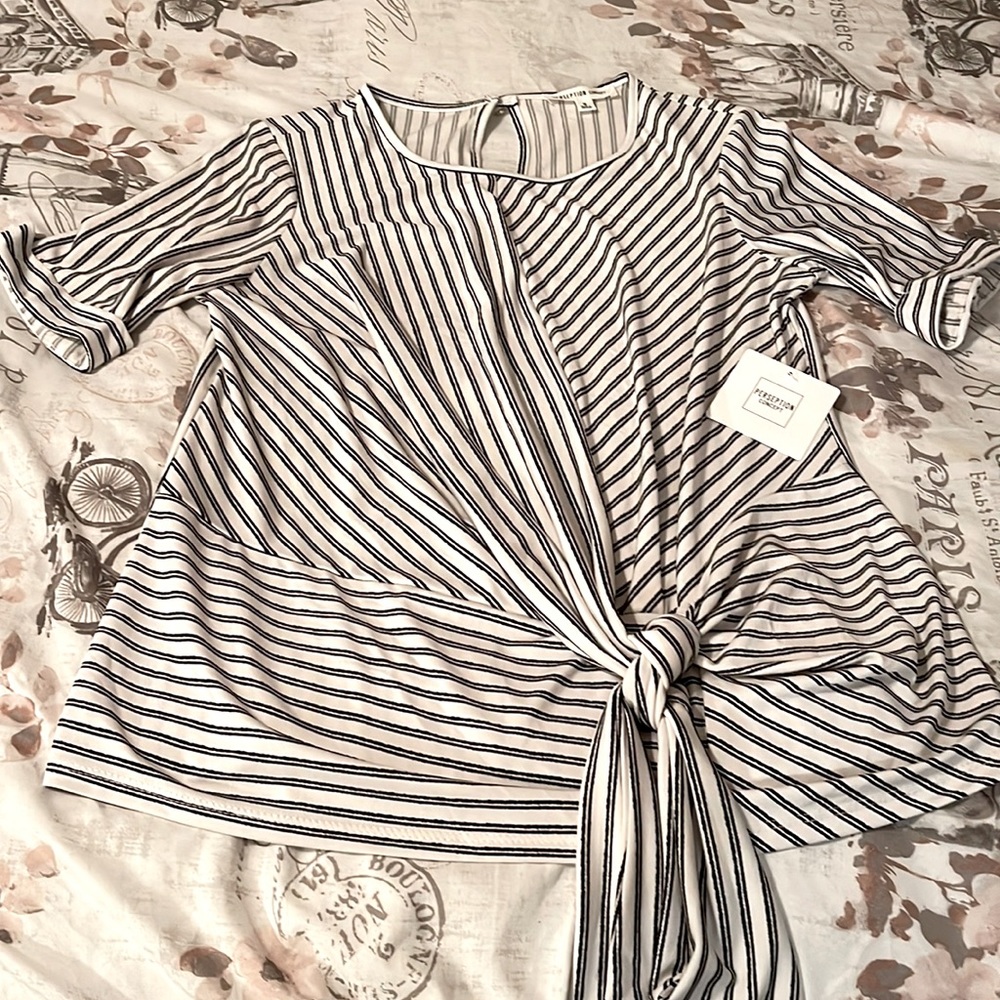 Small black and white blouse with tie on the bottom of blouse